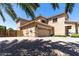 Spacious three-car garage with ample parking space and a well-kept driveway at 18432 W Port Royale Ln, Surprise, AZ 85388