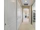 Well-lit hallway features neutral tones and convenient closet space, connecting different areas of the home at 18432 W Port Royale Ln, Surprise, AZ 85388