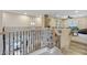 Bright hallway showcases modern railing, an open floor plan, and natural light, creating an inviting transition at 18432 W Port Royale Ln, Surprise, AZ 85388