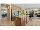 Modern kitchen with an island, granite countertops, and stainless steel appliances at 18432 W Port Royale Ln, Surprise, AZ 85388