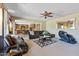 Inviting living room with comfortable seating, ceiling fan, and an open layout at 18432 W Port Royale Ln, Surprise, AZ 85388