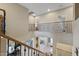 Loft area with wrought iron railing overlooking the lower level at 18432 W Port Royale Ln, Surprise, AZ 85388