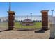 Welcoming entrance to Mark Coronado Park, showcasing well-kept sports fields behind a secure, decorative fence at 18432 W Port Royale Ln, Surprise, AZ 85388