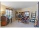 Well-lit home office with built-in bookshelves and a comfortable workspace at 18432 W Port Royale Ln, Surprise, AZ 85388
