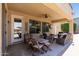 Inviting outdoor patio features a ceiling fan and ample seating, ideal for relaxing and entertaining guests at 18432 W Port Royale Ln, Surprise, AZ 85388