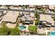 Aerial view of a house with solar panels, a pool, and a well-maintained backyard at 18432 W Port Royale Ln, Surprise, AZ 85388