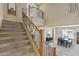 Carpeted staircase with wrought iron railing and a view into the dining and bar areas at 18432 W Port Royale Ln, Surprise, AZ 85388