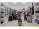 Spacious walk-in closet provides organized storage, custom shelving, and ample room for clothing and accessories at 18432 W Port Royale Ln, Surprise, AZ 85388