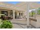 Lovely outdoor patio with a spa, BBQ, and lush landscaping, ideal for relaxation and outdoor enjoyment at 18634 N Paloma Ct, Surprise, AZ 85387
