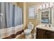 Well-lit bathroom featuring shower-tub combination, and a vanity with generous counter space at 18634 N Paloma Ct, Surprise, AZ 85387