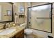 Bright bathroom featuring granite counters, a glass-enclosed shower, and stylish decor at 18634 N Paloma Ct, Surprise, AZ 85387