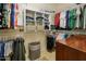 Well-organized walk-in closet with shelving and hanging space for clothes and accessories at 18634 N Paloma Ct, Surprise, AZ 85387