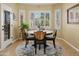 Cozy dining area featuring a round table, stylish chairs, and natural light from the adjacent window at 18634 N Paloma Ct, Surprise, AZ 85387