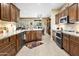 Spacious kitchen with dark wood cabinets, granite countertops, and stainless steel appliances at 18634 N Paloma Ct, Surprise, AZ 85387