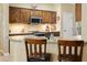 Modern kitchen featuring stainless steel appliances, granite countertops, and barstool seating at 18634 N Paloma Ct, Surprise, AZ 85387