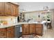 Beautiful kitchen featuring granite countertops, wood cabinets, and a view to the outdoor dining space at 18634 N Paloma Ct, Surprise, AZ 85387