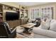Comfortable living room featuring plantation shutters, neutral paint, tile flooring, and a ceiling fan at 18634 N Paloma Ct, Surprise, AZ 85387