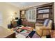 This home office includes a lovely built-in bookcase, natural light, and a cozy atmosphere for productivity at 18634 N Paloma Ct, Surprise, AZ 85387
