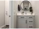 Stylish bathroom featuring a round mirror, white cabinets, and modern fixtures creating a serene and functional space at 1882 S Jesse Pl, Chandler, AZ 85286