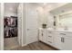 Bright bathroom with double sinks, quartz counters, and modern fixtures, adjacent to a walk-in closet at 1882 S Jesse Pl, Chandler, AZ 85286