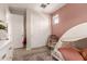 Bedroom features a whimsical canopy bed, soft pink accents, a rattan chair and large closet at 1882 S Jesse Pl, Chandler, AZ 85286