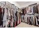 Spacious walk-in closet with organized shelving and hanging rods, offering ample storage for clothing and accessories at 1882 S Jesse Pl, Chandler, AZ 85286