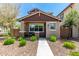 Inviting home with desert landscaping, a covered porch, and a secure gated entry at 1882 S Jesse Pl, Chandler, AZ 85286