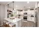 Modern kitchen featuring white cabinets, stainless steel appliances, and a stylish island with seating at 1882 S Jesse Pl, Chandler, AZ 85286