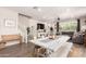 Inviting living room with an open layout, farmhouse dining table, shiplap accent wall, and comfortable gray sectional at 1882 S Jesse Pl, Chandler, AZ 85286