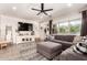 Comfortable living room featuring a shiplap accent wall, large sectional sofa, and natural light at 1882 S Jesse Pl, Chandler, AZ 85286