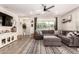 Bright living room with a large sectional sofa, TV, and stylish decor, creating a cozy atmosphere at 1882 S Jesse Pl, Chandler, AZ 85286