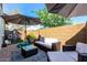 Cozy patio area with comfortable seating, shade umbrellas, and a decorative outdoor rug at 1882 S Jesse Pl, Chandler, AZ 85286