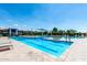 Stunning pool area with clear blue water, poolside seating, and shade offers the perfect spot for relaxation at 1882 S Jesse Pl, Chandler, AZ 85286
