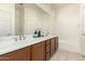 Bright bathroom features a double sink vanity with white countertops and a large mirror at 1887 W Periwinkle Way, Chandler, AZ 85248