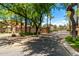 Gated community entrance featuring lush landscaping and a brick-paved street at 1887 W Periwinkle Way, Chandler, AZ 85248