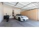 Spacious garage with epoxy floors, built-in storage cabinets, and room for a sports car at 1887 W Periwinkle Way, Chandler, AZ 85248