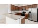 Modern kitchen featuring stainless appliances, ample counter space, and wood cabinetry at 1887 W Periwinkle Way, Chandler, AZ 85248