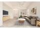 Bright living room with neutral decor, comfortable seating, and modern ceiling fan at 1887 W Periwinkle Way, Chandler, AZ 85248