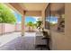 Covered patio featuring brick flooring and outdoor seating with views of the backyard at 1887 W Periwinkle Way, Chandler, AZ 85248