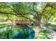 Scenic view of a pond with a charming bridge and lush greenery, perfect for community enjoyment at 1887 W Periwinkle Way, Chandler, AZ 85248