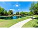 Expansive pond with a paved pathway, adding to the community's recreational appeal at 1887 W Periwinkle Way, Chandler, AZ 85248