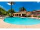 Community pool with lounge seating, a clubhouse, and palm trees surrounding the area at 1887 W Periwinkle Way, Chandler, AZ 85248