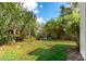 Green backyard featuring a stone fountain, lush landscaping, and privacy-enhancing vegetation at 19013 N 18Th Ave, Phoenix, AZ 85027