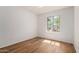 Bright bedroom with wood floors, white walls, and a large window providing natural light at 19013 N 18Th Ave, Phoenix, AZ 85027