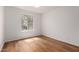 Bright bedroom with wood floors, white walls, and a large window providing natural light at 19013 N 18Th Ave, Phoenix, AZ 85027