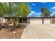 Charming single-story home featuring desert landscaping, a two-car garage, and a brick facade at 19013 N 18Th Ave, Phoenix, AZ 85027