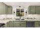 A close up of the marble countertops, stainless steal sink, and light fixtures in this newly renovated kitchen at 19013 N 18Th Ave, Phoenix, AZ 85027