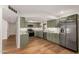 Modern kitchen boasts stainless steel appliances, marble countertops, and beautiful green cabinets at 19013 N 18Th Ave, Phoenix, AZ 85027
