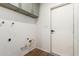 Interior laundry room with white walls, modern fixtures, and wood floors at 19013 N 18Th Ave, Phoenix, AZ 85027