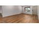Bright living room with hardwood floors, white walls, base molding, and natural light from a window at 19013 N 18Th Ave, Phoenix, AZ 85027